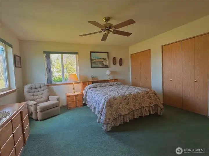 Classic French-style double closet doors in primary bedroom.