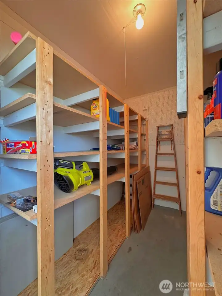 Storage room inside garage with shelving for convenient and accessable storage