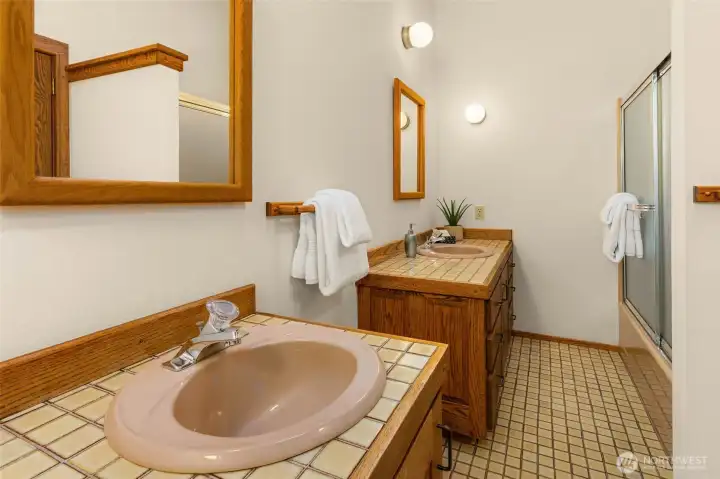 Full main level hall bath with dual vanities.