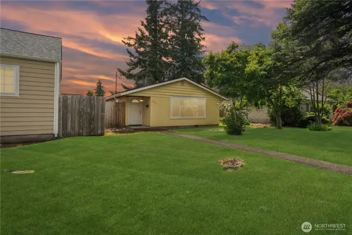 Twilight view of the expansive front yard showcasing outdoor living potential, privacy, and the generous lot size that makes this affordable Enumclaw home stand out from the competition. Twilight view of the expansive front yard showcasing outdoor living potential, privacy, and the generous lot size that makes this affordable Enumclaw home stand out from the competition.