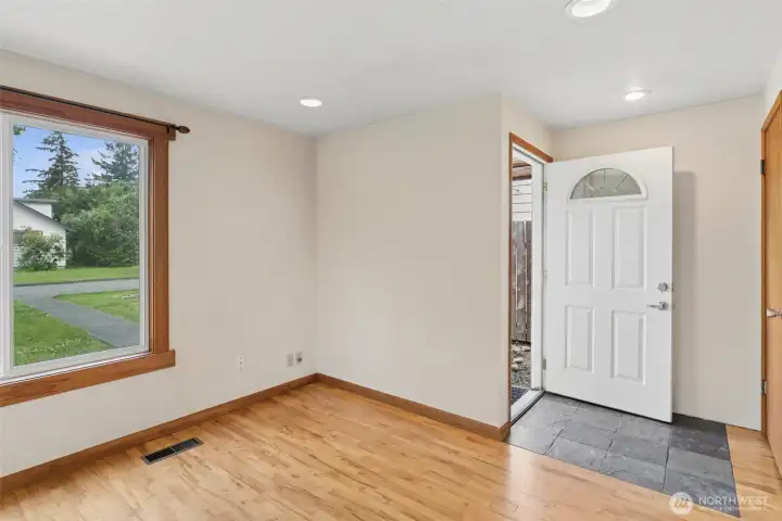 Light-filled living room with large picture windows bringing in abundant natural light while showcasing the home's warm and inviting interior. Light-filled living room with large picture windows bringing in abundant natural light while showcasing the home's warm and inviting interior.
