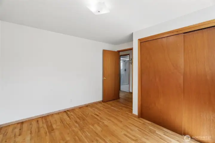Primary bedroom with hardwood flooring, generous closet space, and a comfortable layout ready for your personal touches. Primary bedroom with hardwood flooring, generous closet space, and a comfortable layout ready for your personal touches.