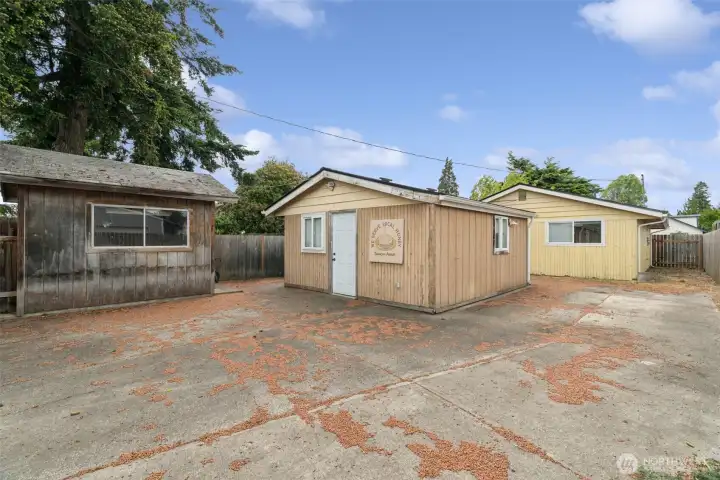 Detached outbuilding and expansive backyard create endless possibilities for storage, projects, gardening, or future property enhancements. Detached outbuilding and expansive backyard create endless possibilities for storage, projects, gardening, or future property enhancements.