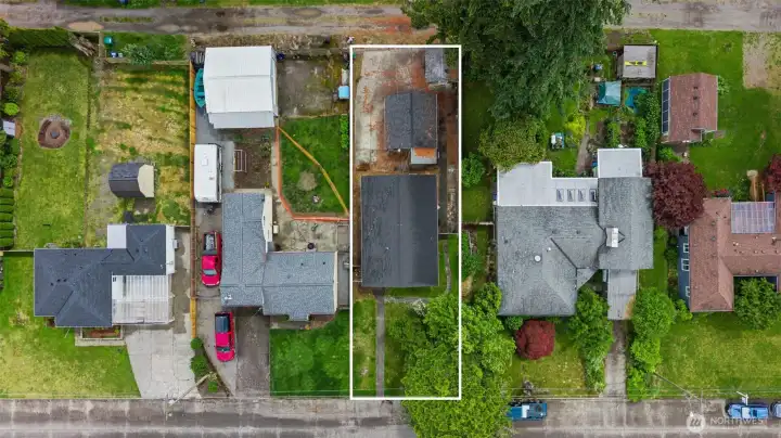 Bird's-eye view highlights the oversized 8,320 sq ft lot, alley access, detached outbuilding, and ample outdoor space. Bird's-eye view highlights the oversized 8,320 sq ft lot, alley access, detached outbuilding, and ample outdoor space.