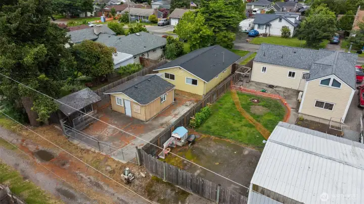 Aerial property view showcasing the oversized 8,320 sq ft lot, detached outbuilding, alley access, and exceptional outdoor space rarely found at this price point in Enumclaw. Aerial property view showcasing the oversized 8,320 sq ft lot, detached outbuilding, alley access, and exceptional outdoor space rarely found at this price point in Enumclaw.