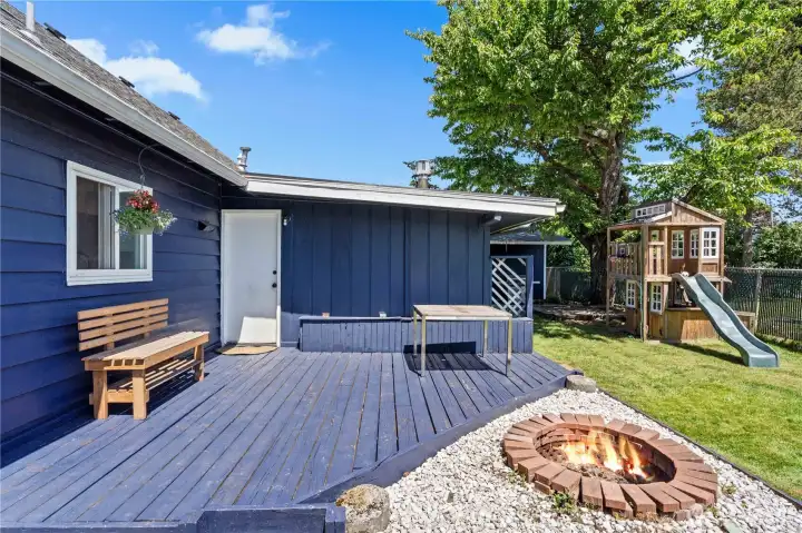 Backyard deck has bench seating with storage.