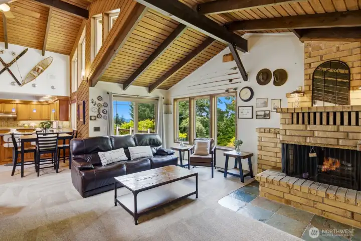Statement fireplace with a multi-level stone mante. Slider to entertainment-size deck