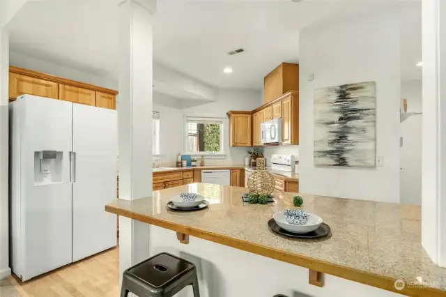 Kitchen with island offering additional storage and counter space.