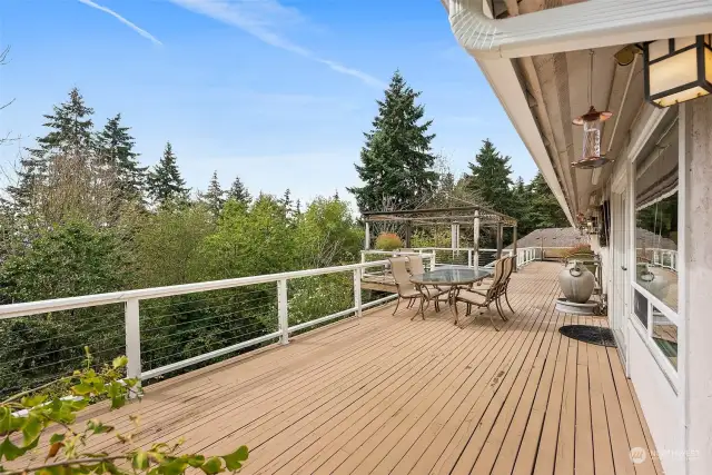 Deck with hot tub, sitting area, outdoor dining