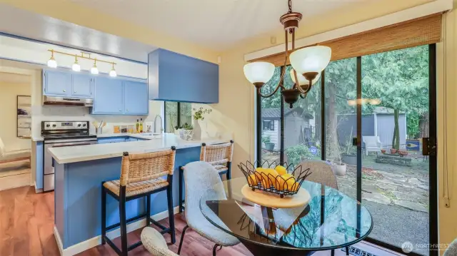 Cozy dining nook just off the kitchen offers direct access to the park-like backyard, ideal for indoor/outdoor living.