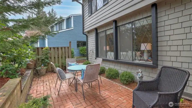 Enjoy a slow morning with your coffee on this darling front paver patio.