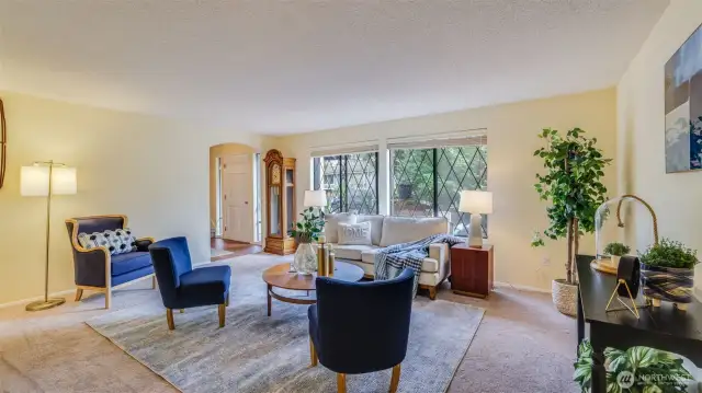 Enjoy a wall of windows in this formal living room providing ample natural light.
