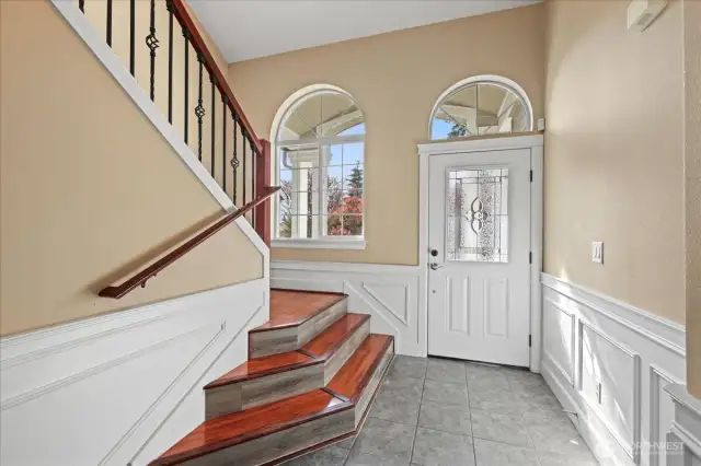 Foyer with a sneak peak at the shadow box wainscoting and crown molding that is seen throughout the home