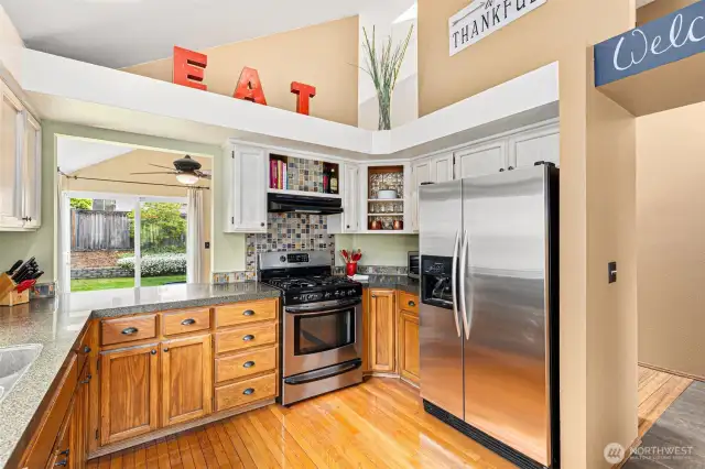 Stainless steel appliances, gas stovetop + cool architectural design.