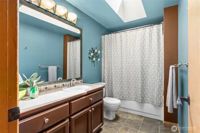 Upstairs main bath with great colors and skylight.