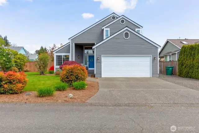 Lovely landscaping, attractive paint & a brand new roof!