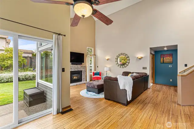 The slider, screen and ceiling fans keep things cool.  Off in the distance, you see the entry to the main level Primary bedroom suite.