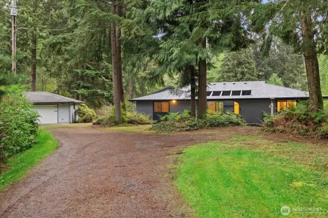 The detached garage is to the left, exterior of the home is well maintained.