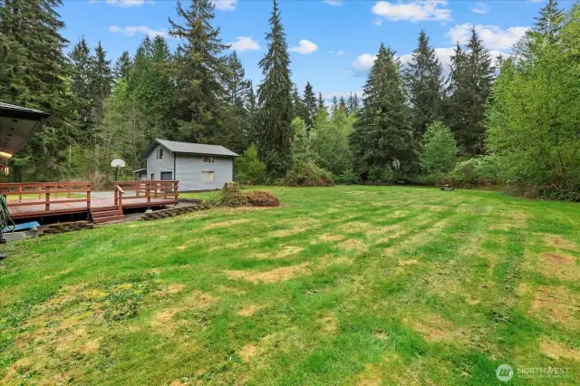Septic access to the right of the home. Gun shooting backstop to right of cabin to the far E of the yard.