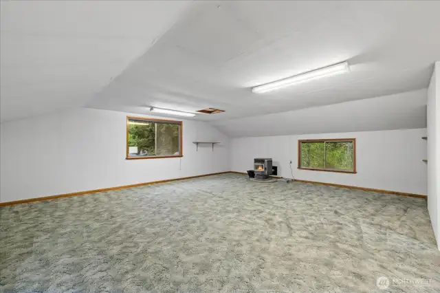 Electricity and pellet stove as heat source, nook to the left of stairs could be a bathroom, cabinets and shelves could be converted into a kitchenette.
