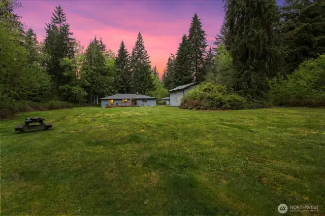 Crack a crisp beverage and park it here for bon fires and bbq's, this yard is made for it all. This home presents endless options.