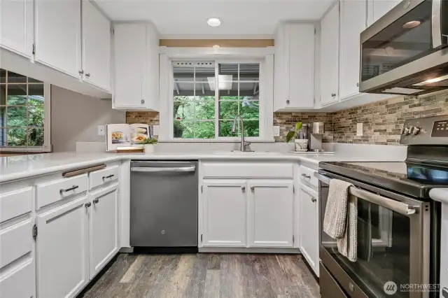 plenty of cabinets plus small pantry behind photogher