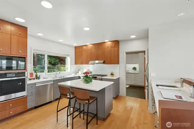 Remodeled kitchen with new counters & designer backsplash, newly painted cabinets, & new stainless steel appliances