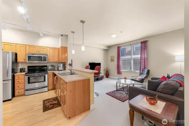 Laminate hardwood floor and light cabinets lend charm to this open floor plan.