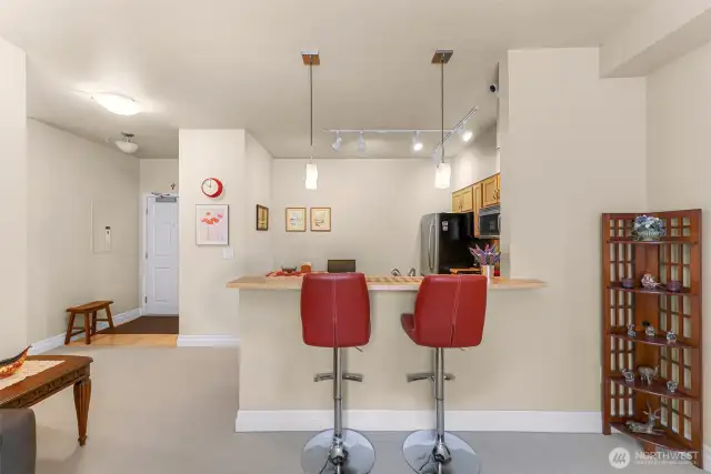 Cheery view of open kitchen and entry hall.