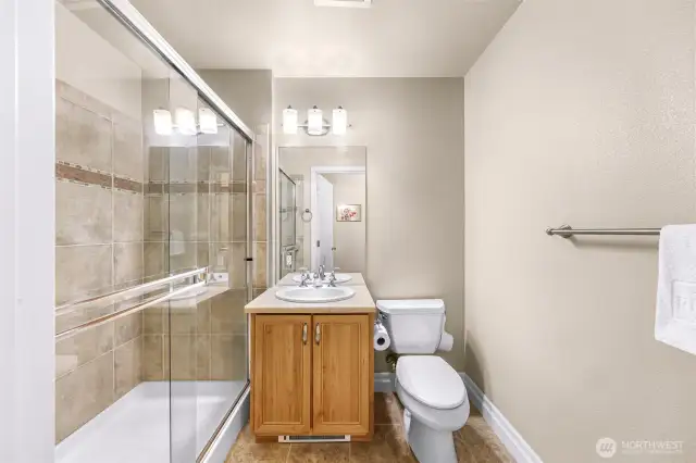 Tiled walk-in shower in guest bathroom.