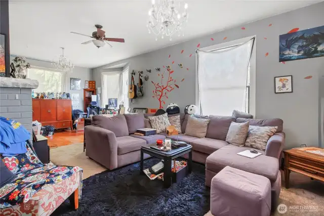 The living room and dining room are large in size, just look past all of the personal items.