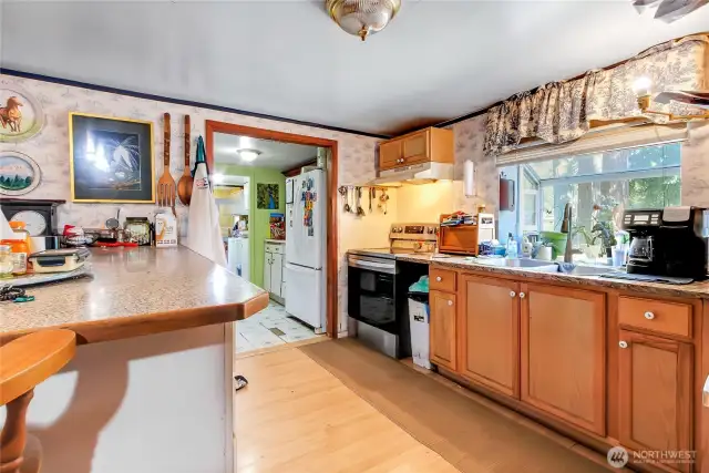 more of the kitchen. Lots of counters and cabinets here