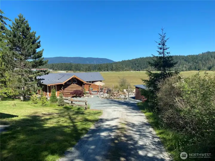 The Log Cabin Cottage sits nestled on the west side of East Crow Valley, tucked in between Preservation Trust acreage and Turtleback Mountain to the west and Conservation Agricultural Open Space easement on the east with Mount Constitution watching over the valley.