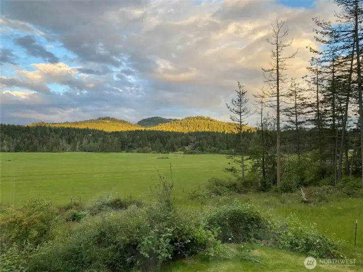 View to the southeast, sunset color on Sunset Mountain. The view is "ever changing" with the seasons, sun and moon.