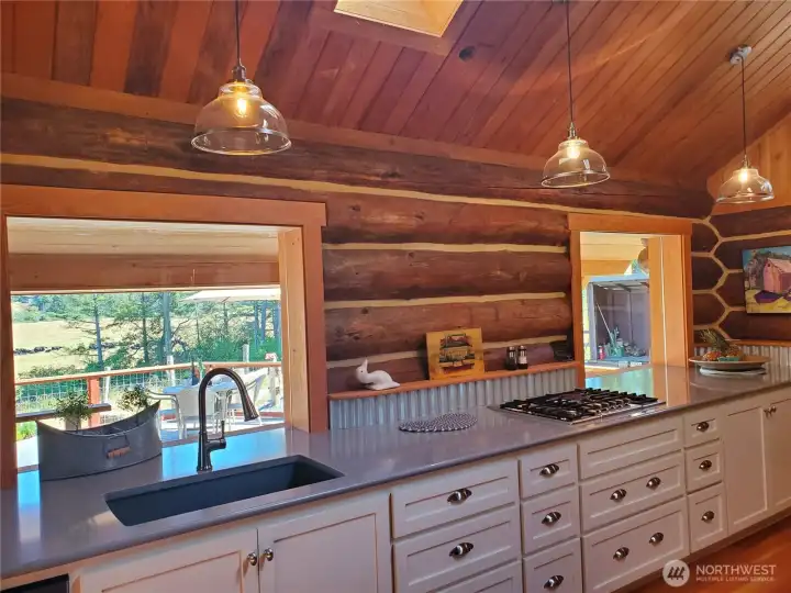 Cabinetry, back splash and local fir framed windows - all custom built by local craftsman. Views across deck, patio to the south, southeast.