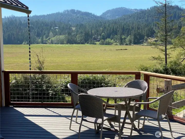 This deck adds outdoor space that can be used year round. Looking out over the southeast corner of the property across the adjacent farm land, protected by open space conservation easement.