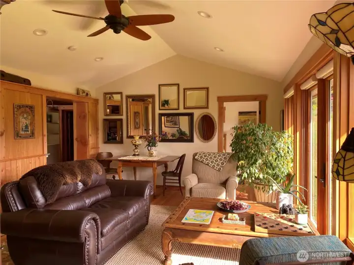 Vaulted ceilings and fans in both bedrooms and the main living room. Open floor plan and large windows welcomes year round natural light. Open door accesses the guest bedroom.