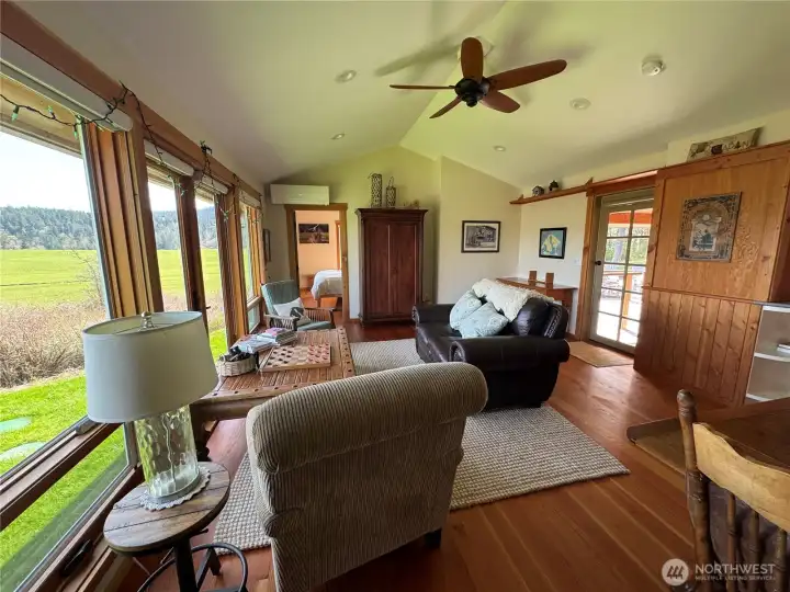 Open door in the middle of the picture accesses the main bedroom ensuite. Glass door to the right accesses the covered porch and deck area.