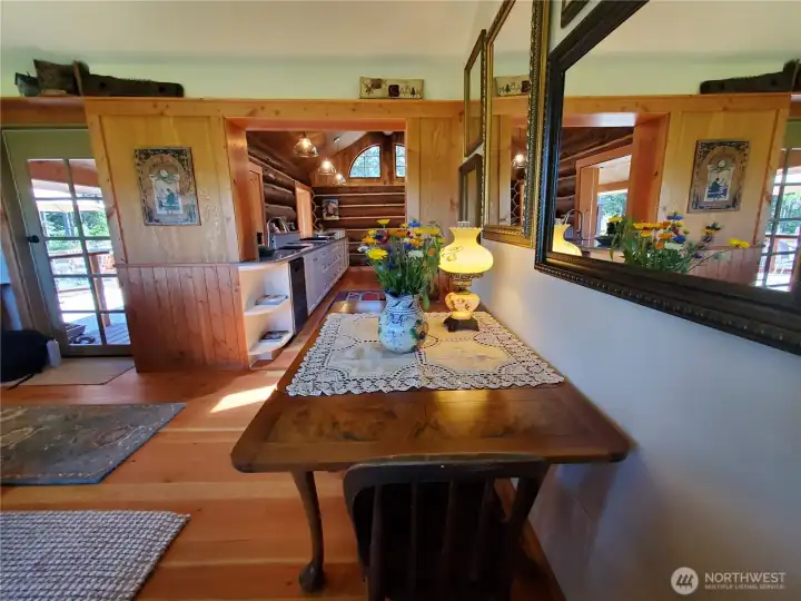 Dining area looks into the kitchen and out to covered porch and patio area.