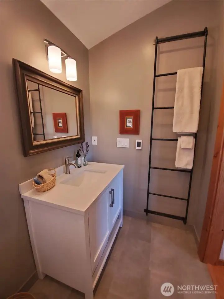 Main ensuite bath, radiant floor heat, vaulted ceiling, natural light, includes walk-in shower.