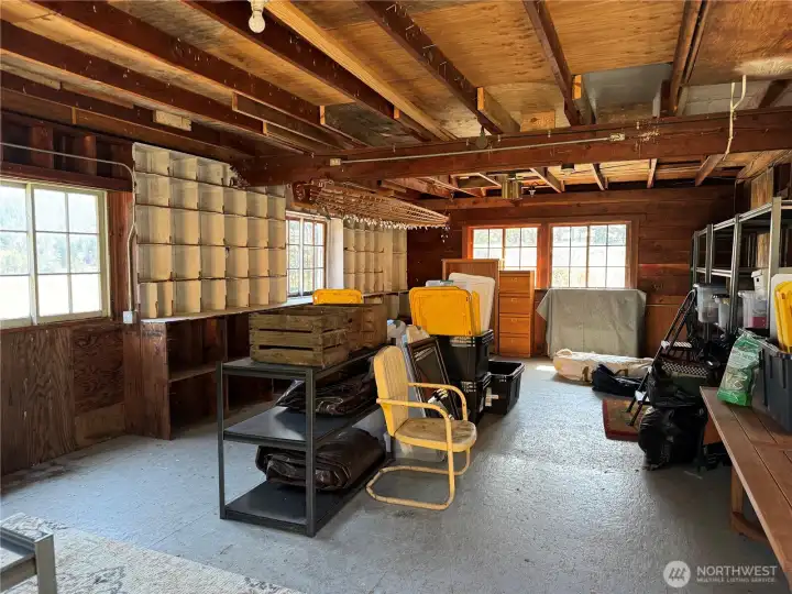 The interior of the 30x30 storage building. Built in cubby holes, shelving and a pull down ladder for loft storage. Power has been stubbed out to this structure. One new window installed. Dry crawl space with head room to store your kayaks and outdoor gear.