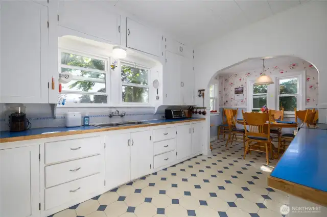 Vintage charm everywhere!  Original cabinetry offers lots of storage.  Tons of counter space.  Another arched doorway leads to the breakfast nook.