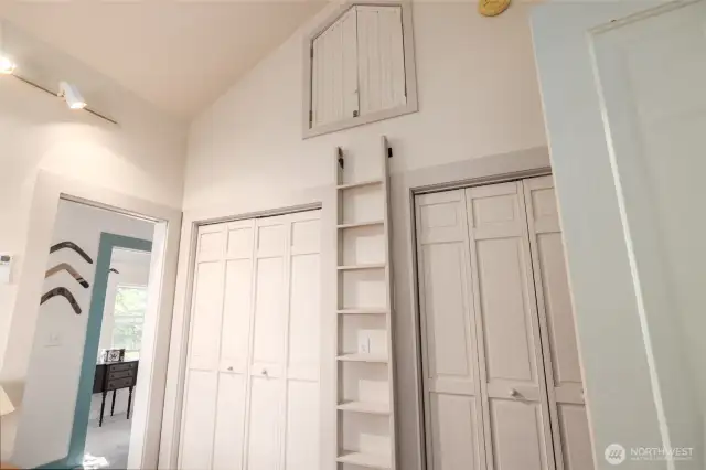 Built-in ladder to reach the extra storage area above double closets in the upstairs primary suite.