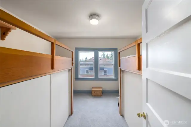 The bunkroom comes with platform beds and storage/closets below.