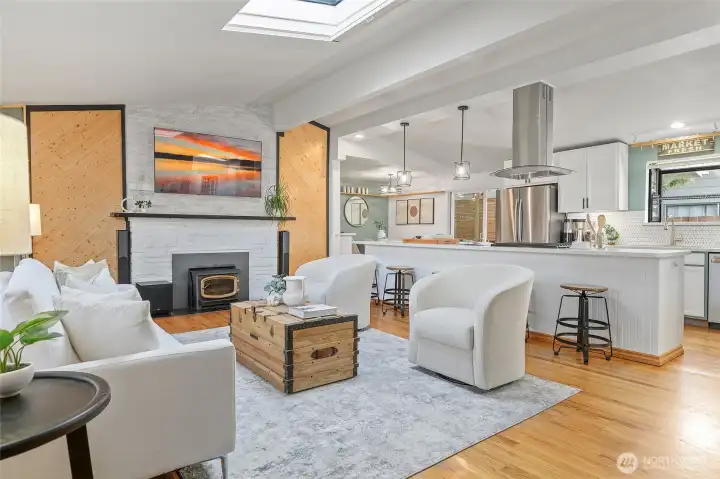 Spacious living room with hardwoods, vaults & skylight.
