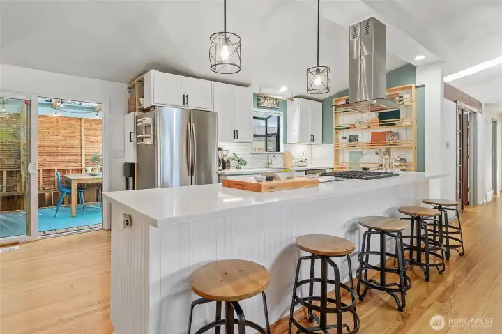 All quartz center island with plenty of eating/entertainment space. Sliders that access covered outdoor space.