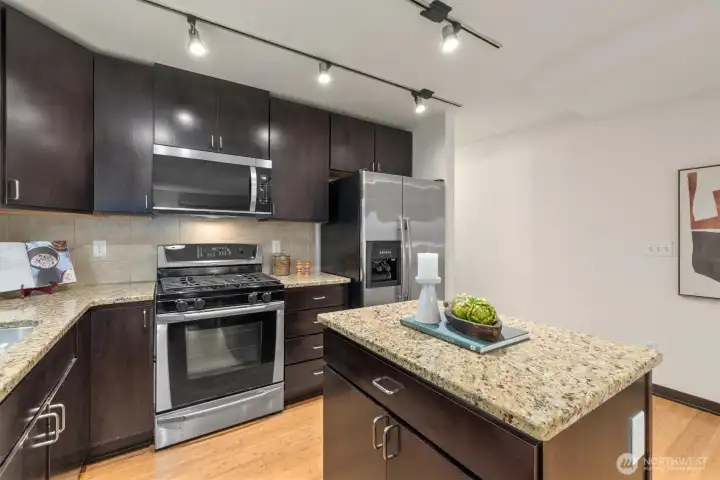 Roomy kitchen with gas range and new microwave! Bar seating on the kitchen island is an easy install