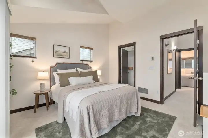 Large primary with vaulted ceilings and walk-in closet