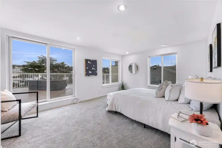 Primary bedroom with walk-in closet, ensuite bath, and direct deck access.