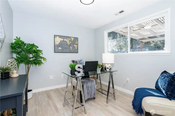 This flex space is staged as a home office, showing its versatility. There’s enough room for dual desks or a full workstation, making it ideal for remote work, creative projects or study space. The window keeps the room feeling open rather than enclosed, and the flooring continuity maintains the home’s updated feel.